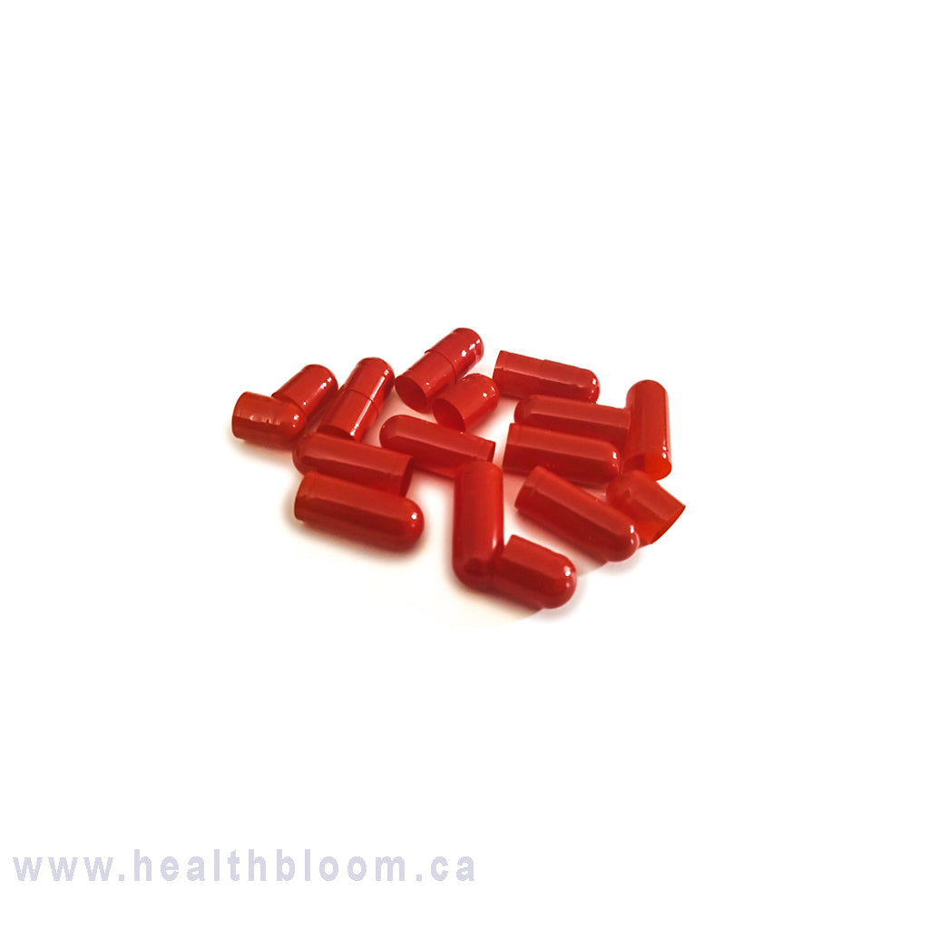 A pile of separated red empty gelatin capsules size 00 on a white background with Health Bloom's watermark.