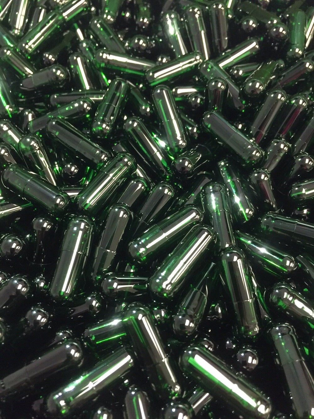 A close-up view of green empty vegetable capsules arranged closely together.
